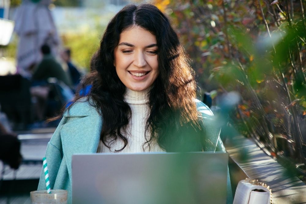 A woman using her laptop with peace of mind.