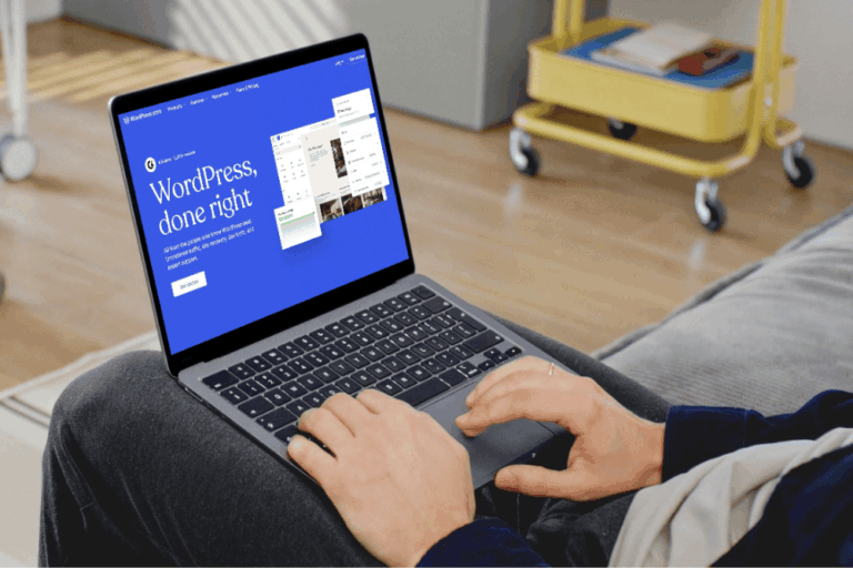 Man using a laptop with WordPress homepage on screen, representing WordPress vs Wix comparison.