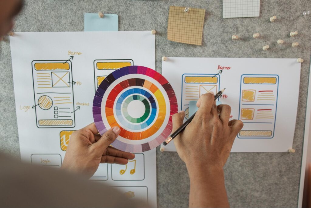 Web designer planning website layout on a pin board to illustrate WordPress design flexibility.