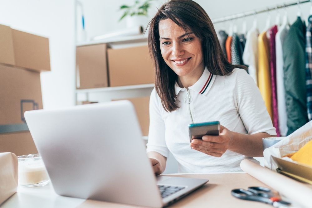 Small business owner smiling while implementing new campaign strategies.