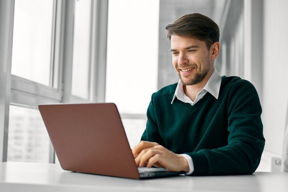 Man smiling while managing successful ad performance after adapting to the Meta Andromeda update.