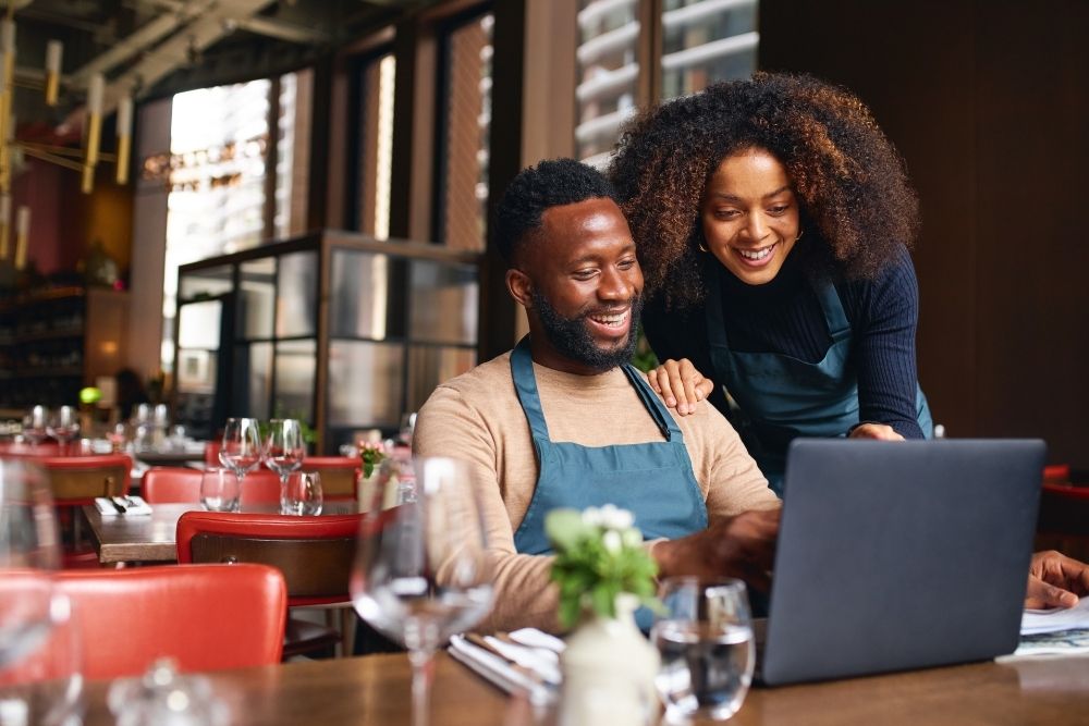 Local business owners smiling after  increased leads.