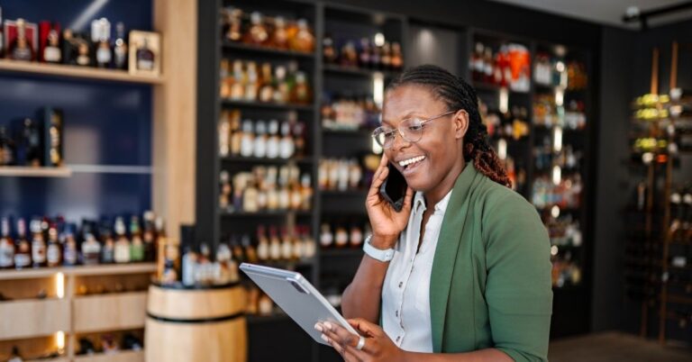Business owner answering a client call quickly to optimize lead response time and win the job.