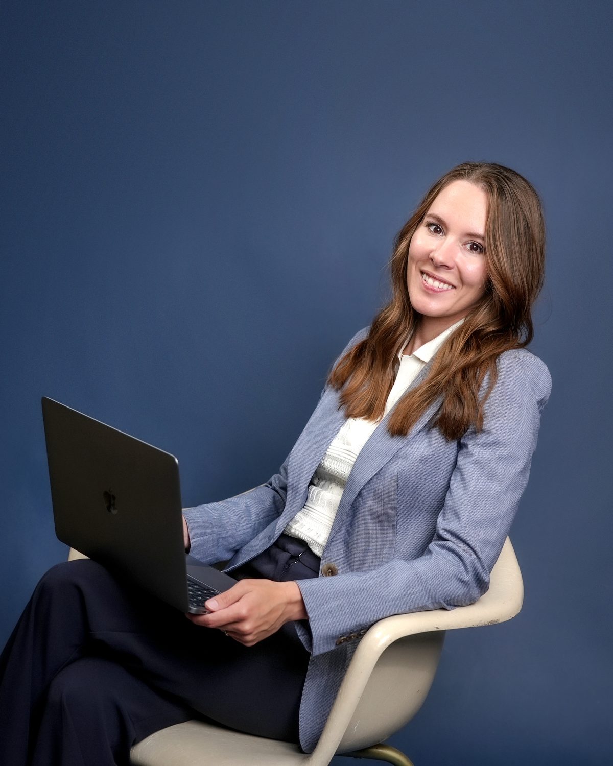Megan Dornbusch, webmaster and copywriter at Central Lakes Digital, working on a laptop